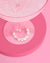 Pearl wine glass charm with 'CUTE' on a pink background