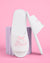 White sandal with 'Bride' embroidery on a pink background