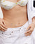 Person wearing a 'Bride' necklace with a white bikini top and jeans.