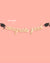 Graduation-themed decorative string with 'congrats grad' on a pink background
