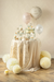 Decorative table setup with balloons and party favors on a beige background