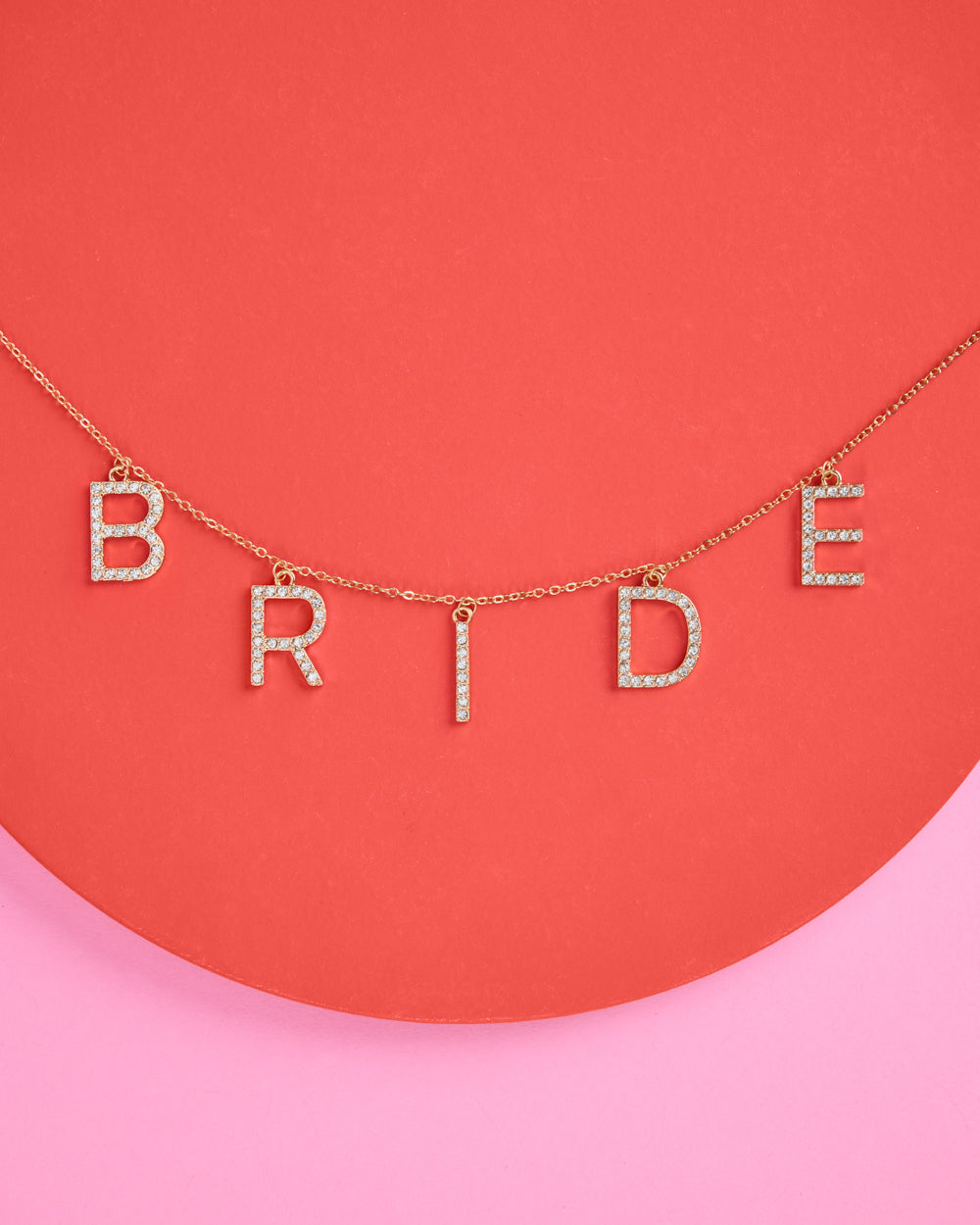 Necklace with 'BRIDE' letters on a pink and red background