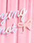 Iridescent 'trying not' banner on a pink background