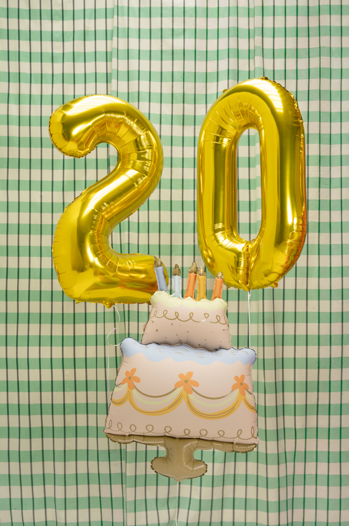Balloon shaped like a birthday cake with candles on a white background