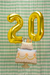 Balloon shaped like a birthday cake with candles on a white background