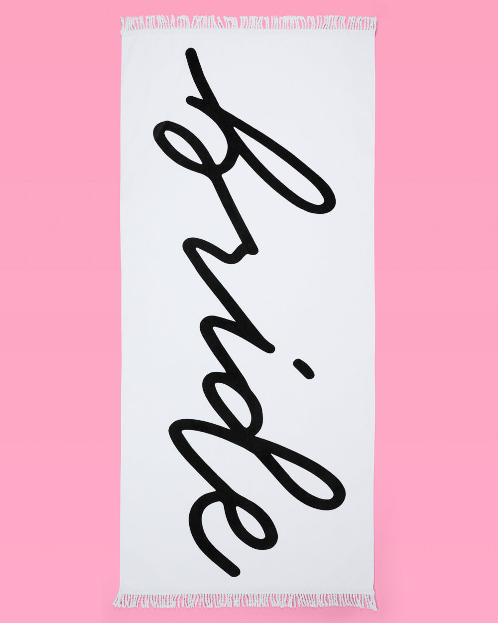 White towel with 'Bride' in black cursive text draped over a white railing outdoors.