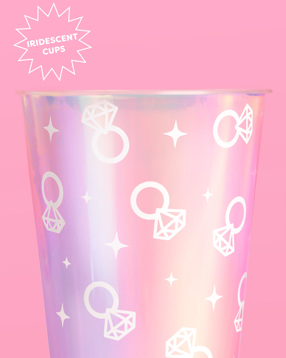 Iridescent cup with diamond ring and star pattern on a pink background