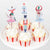 Cupcakes with decorative Nutcracker-themed toppers on a white plate.