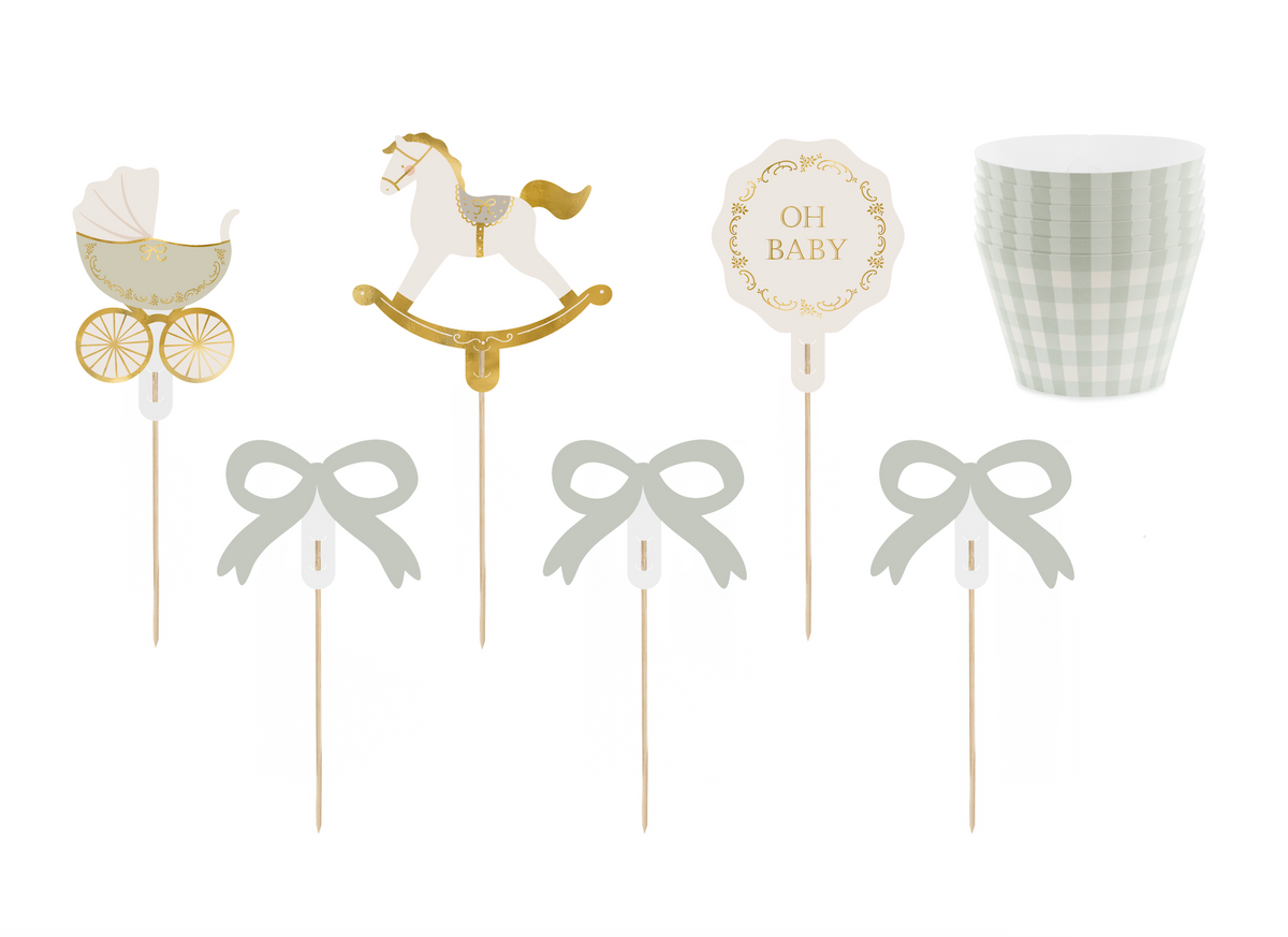 Decorative items on sticks including a baby carriage, rocking horse, and &#39;Oh Baby&#39; sign with checkered cupcake liner.