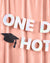 Holographic 'ONE DAY HOT' banner with a graduation cap on a pink curtain background