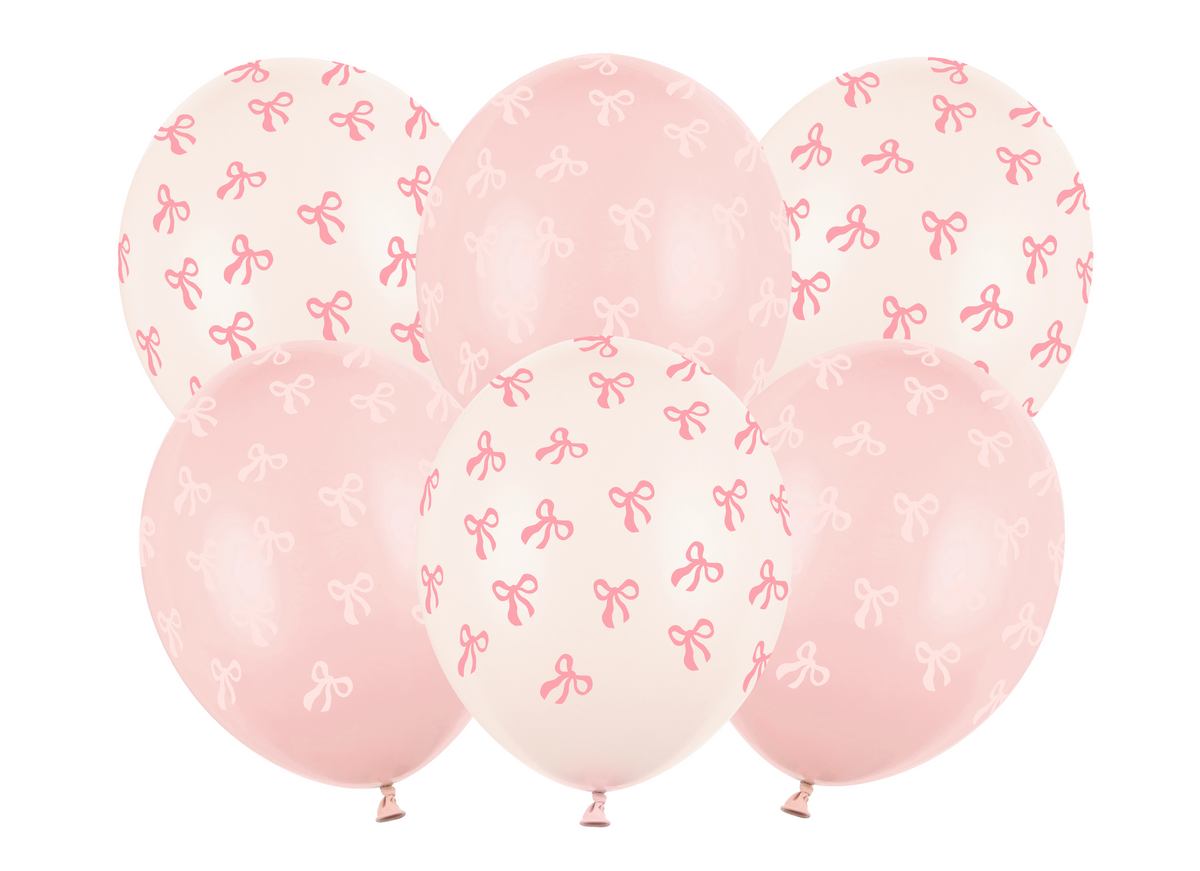 Pink balloons with bow patterns on a white background