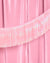 Iridescent tinsel ribbon on a pink background