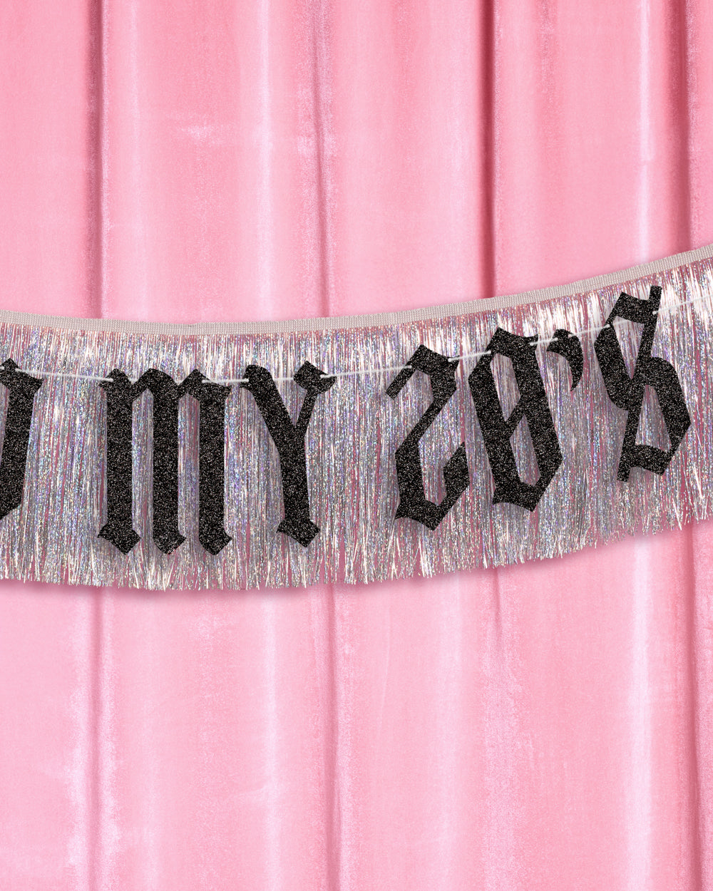 Decorative banner with 'Kiss to my 28's' text on a pink background, with a table set for a party below.