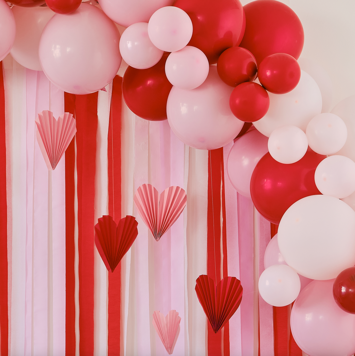 Red &amp; Pink Balloon Arch Party Backdrop with Streamers and Heart Decorations