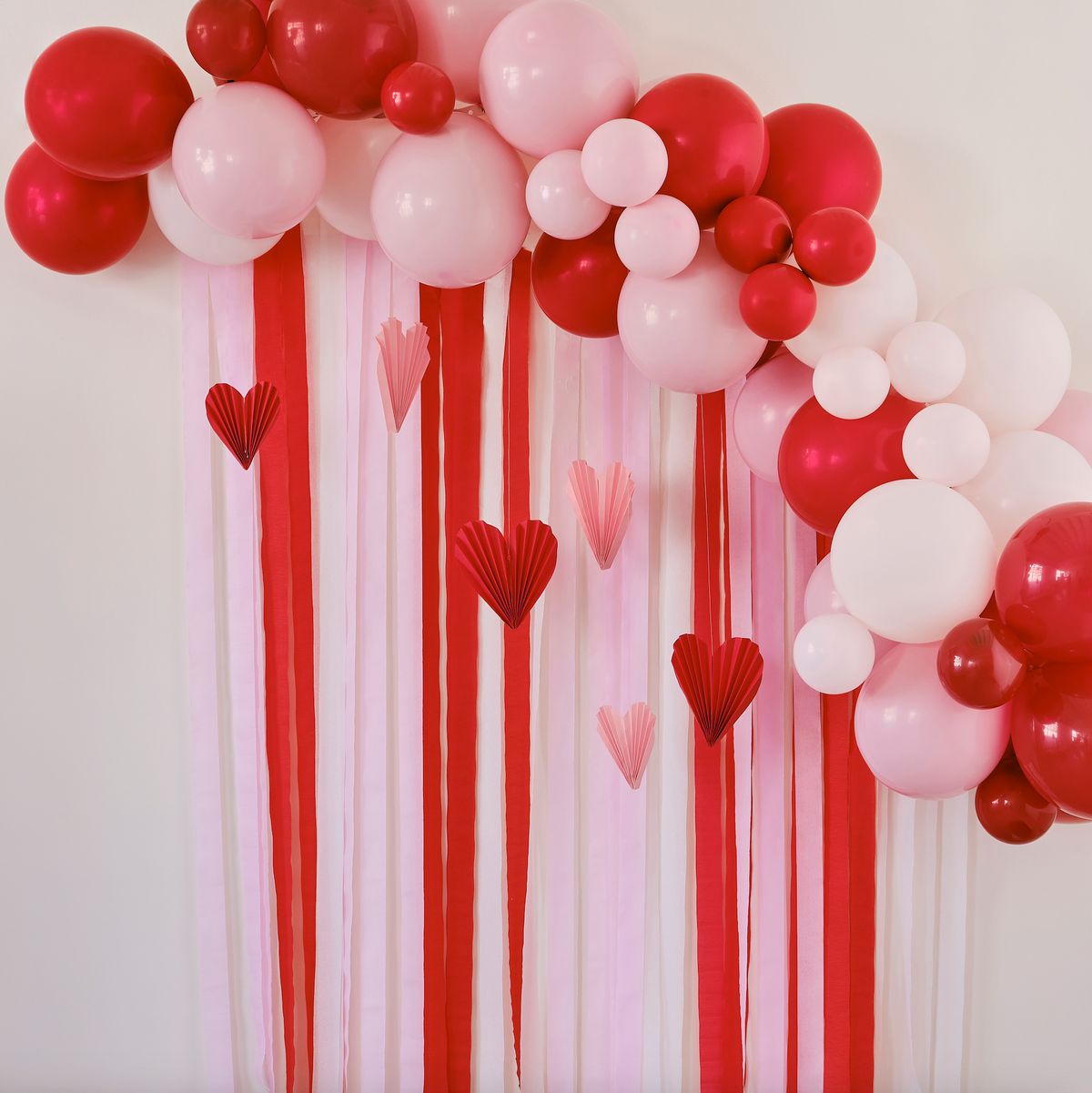 Red &amp; Pink Balloon Arch Party Backdrop with Streamers and Heart Decorations