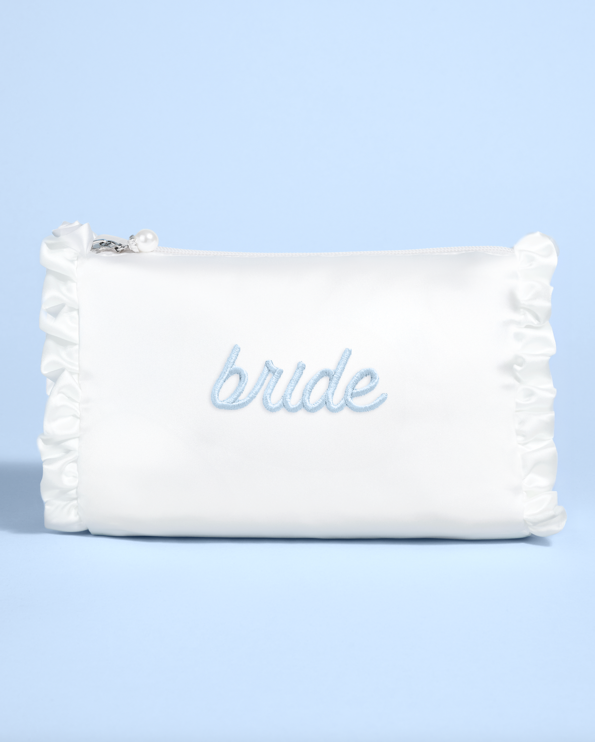 White pouch with &#39;bride&#39; embroidery on a light blue background
