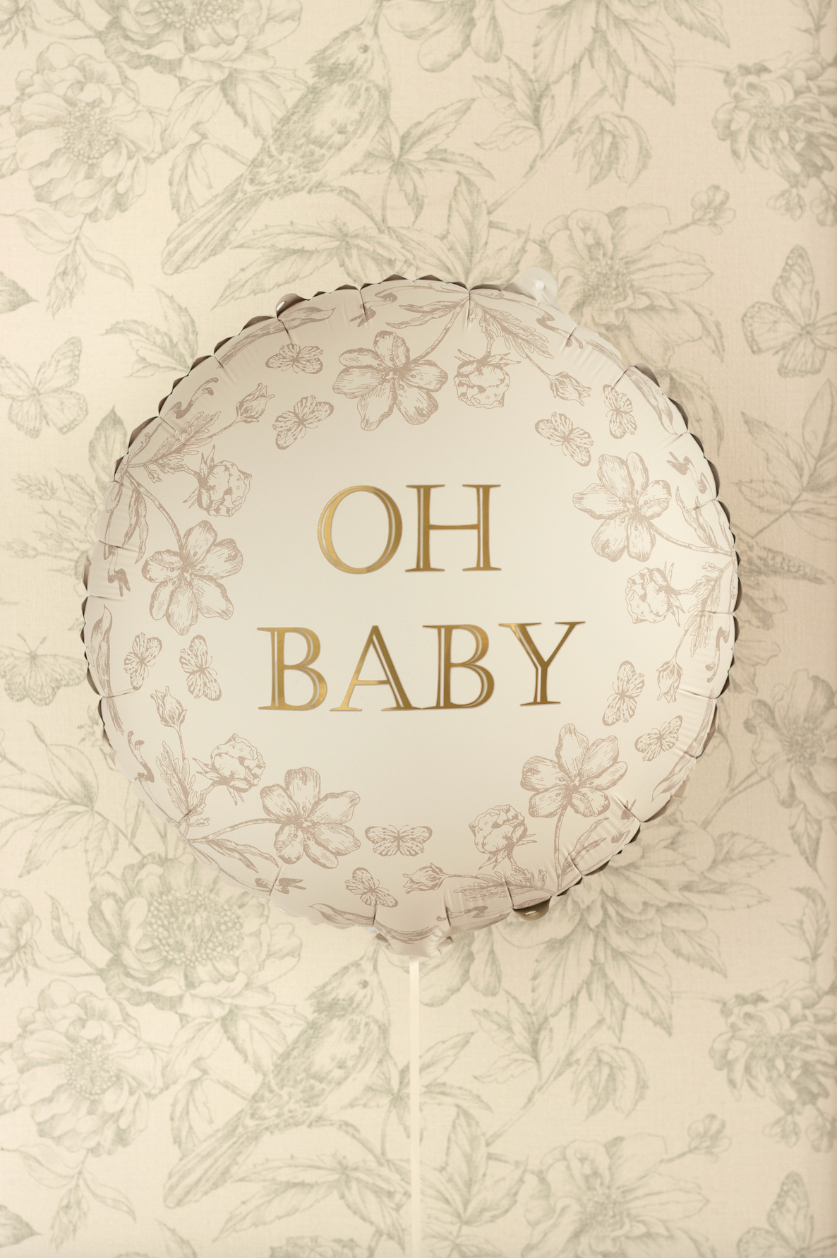 Decorative balloon with &#39;OH BABY&#39; text on a floral patterned background