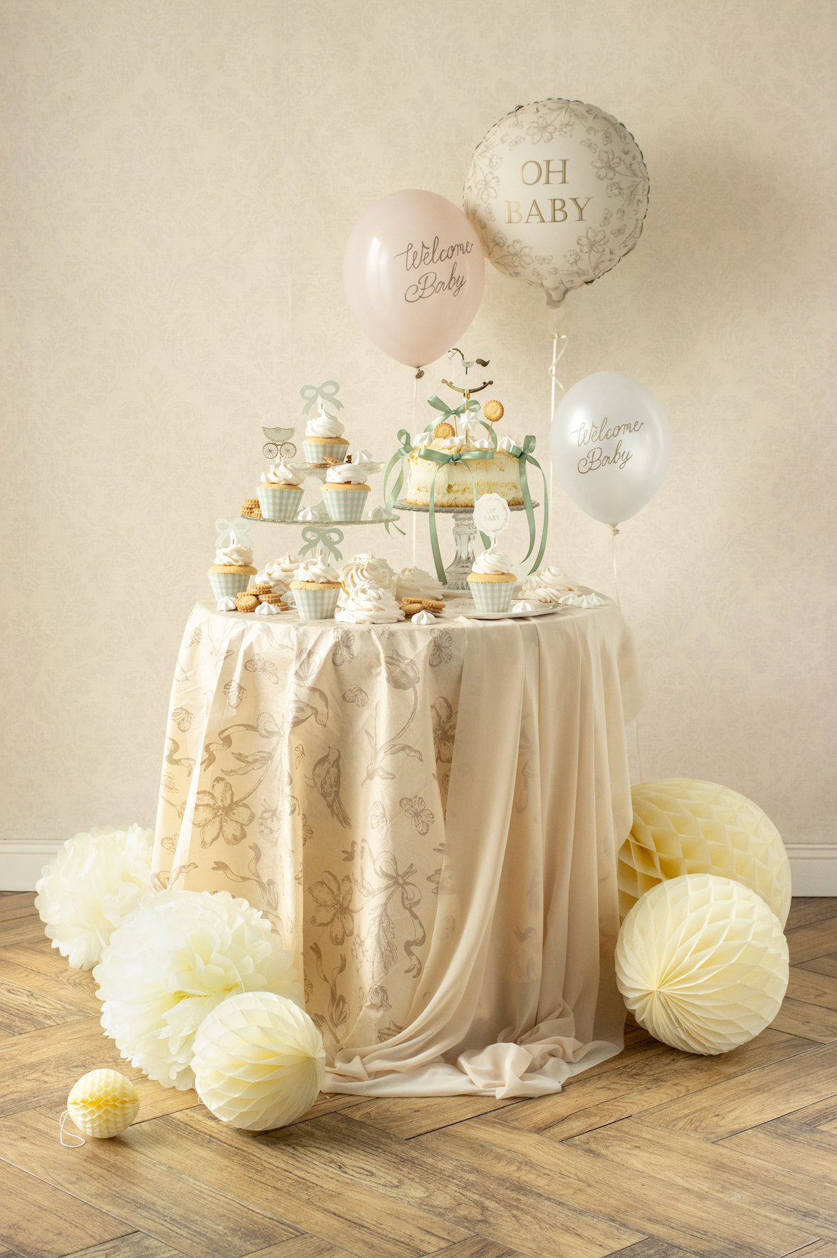 Decorative table setup with balloons and party favors on a beige background
