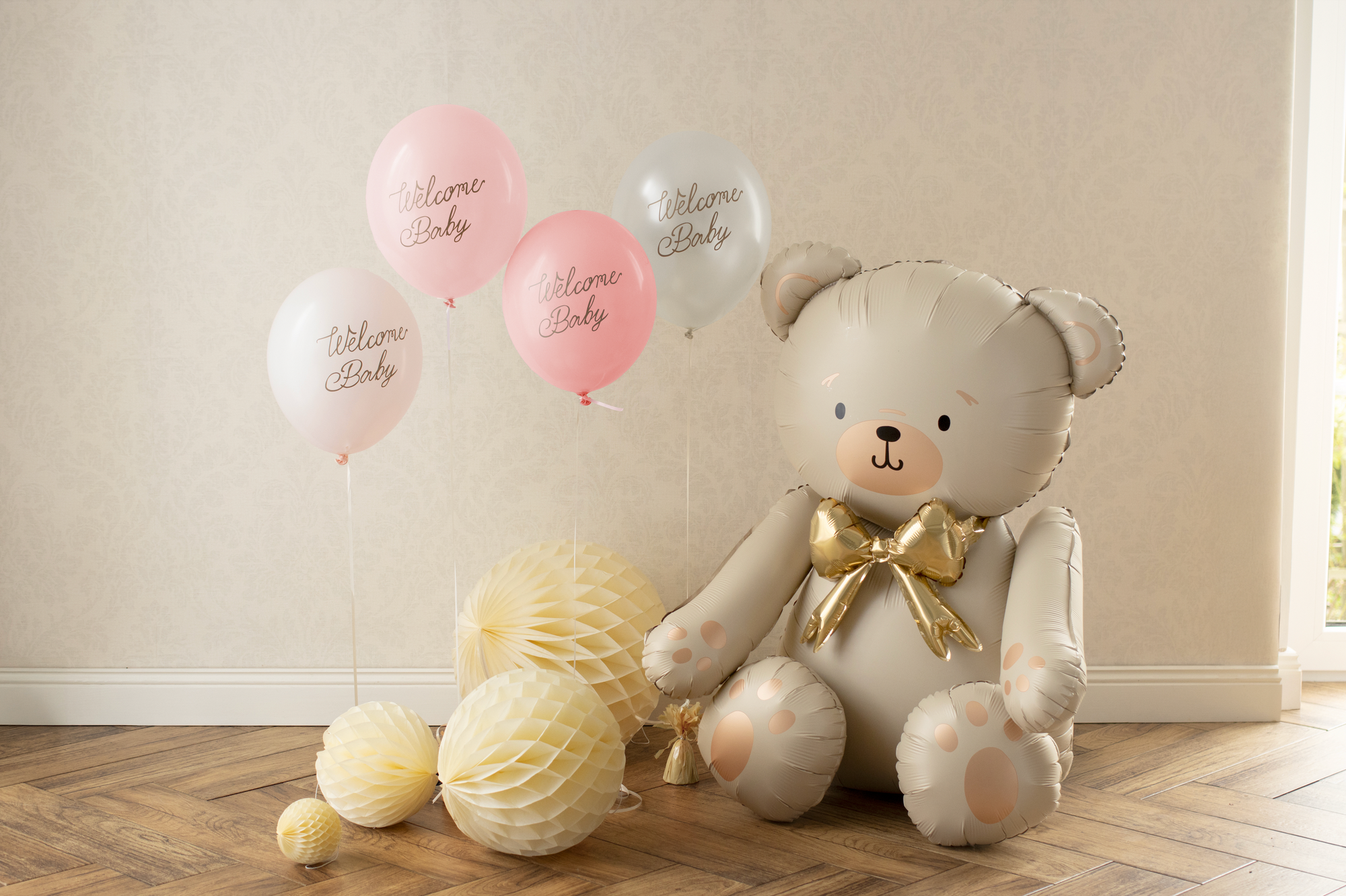 Pink and white balloons with 'Welcome Baby' text on a white background