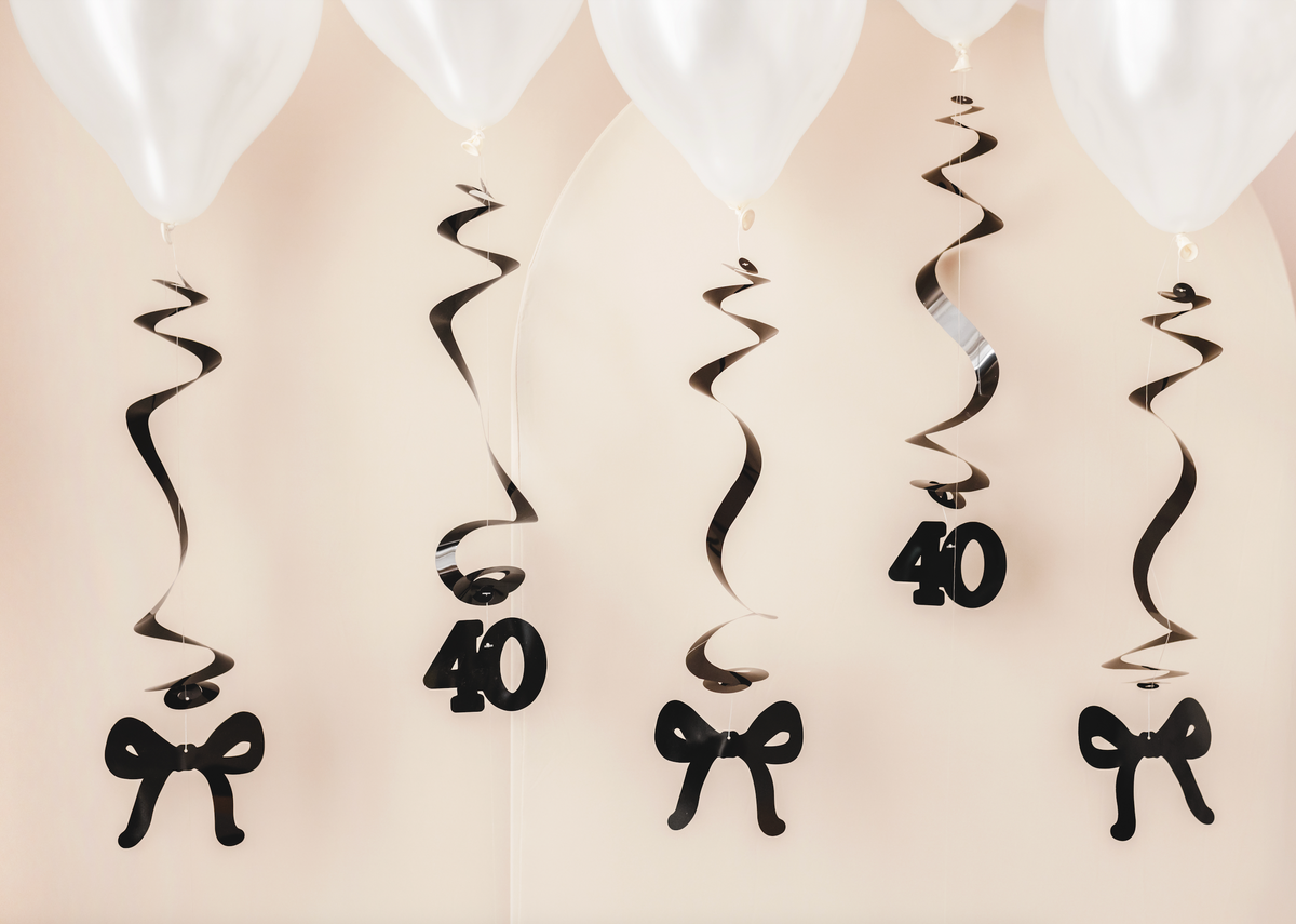 Decorative hanging swirls with number &#39;40&#39; and bow design on a beige background