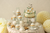 Decorative items on sticks including a baby carriage, rocking horse, and 'Oh Baby' sign with checkered cupcake liner.