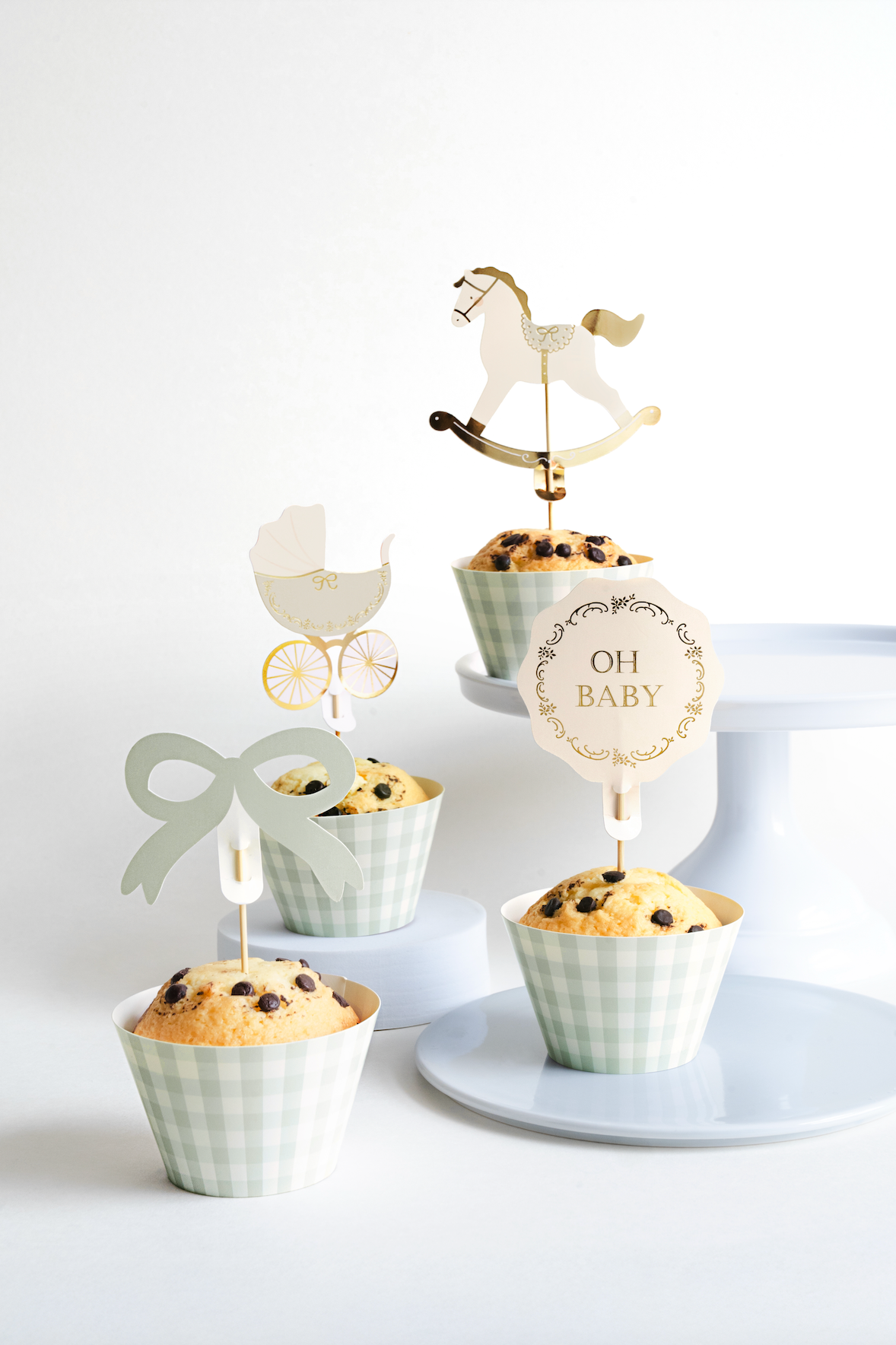 Muffins with decorative toppers on a white background
