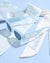 White sash with 'bride to be' text, sunglasses, and a brooch on a light blue background