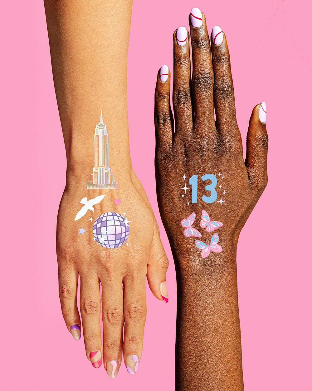 Two hands with colorful temporary tattoos on a pink background