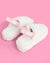 White fluffy slippers with 'Bride' straps on a pink background
