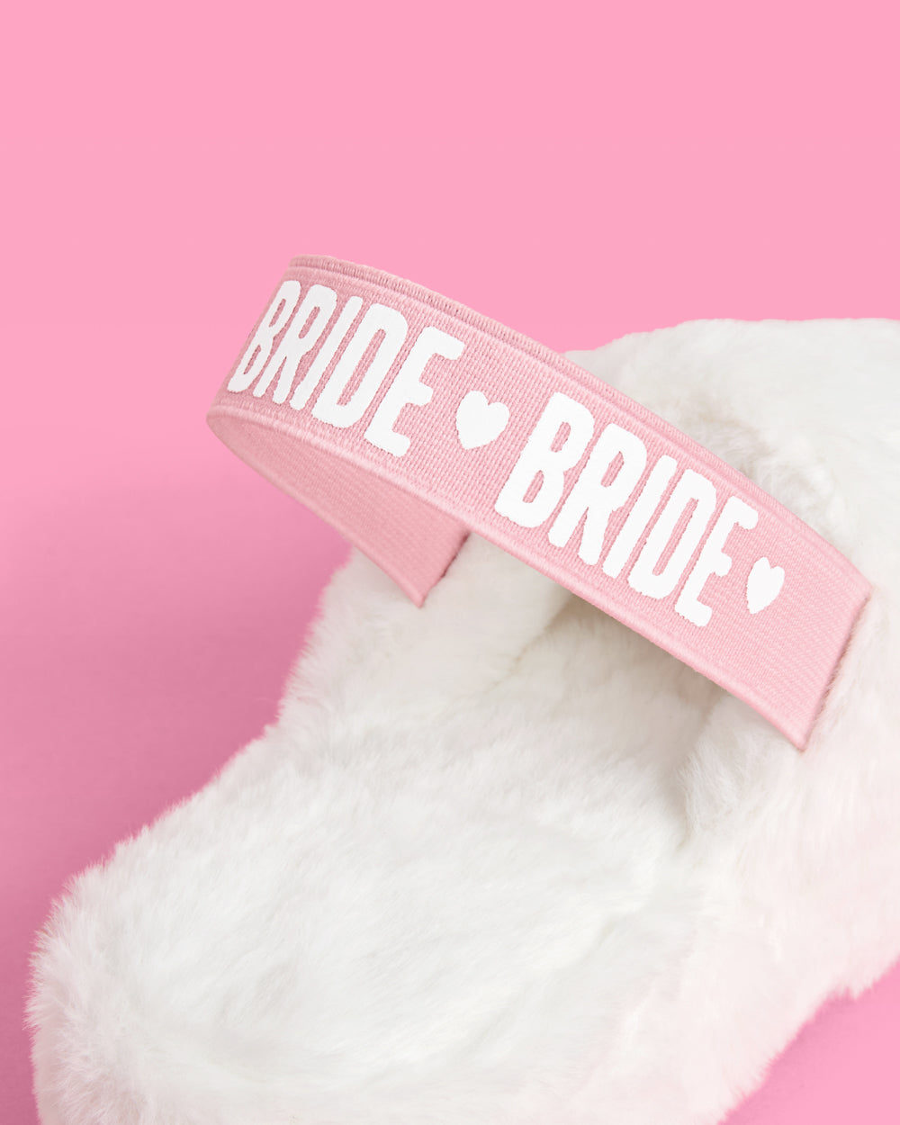 Pink headband with &#39;BRIDE&#39; text on a pink background