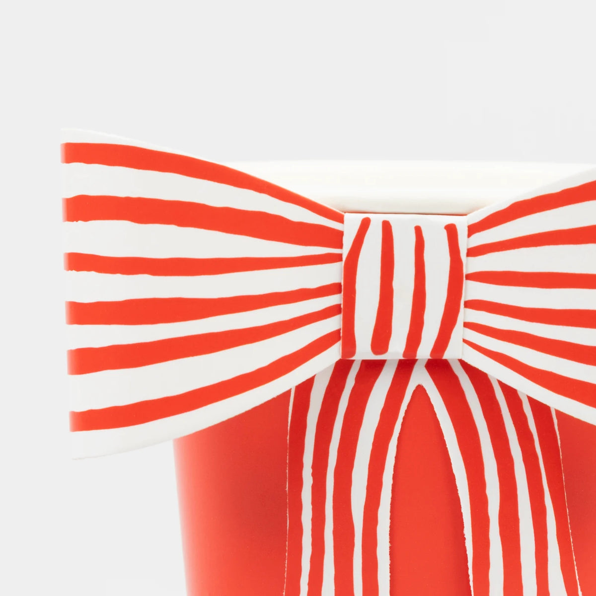 Red and white striped bow on a white background