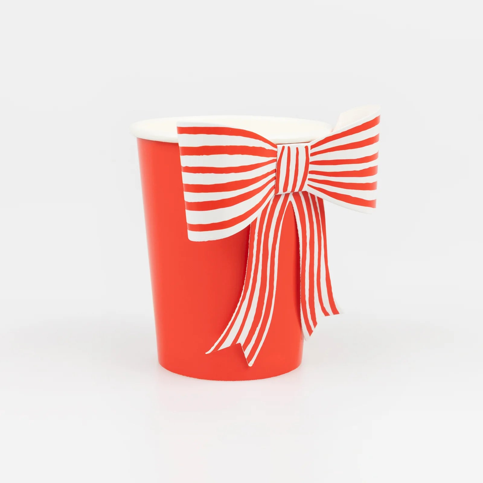 Red cup with a white bow design on a white background