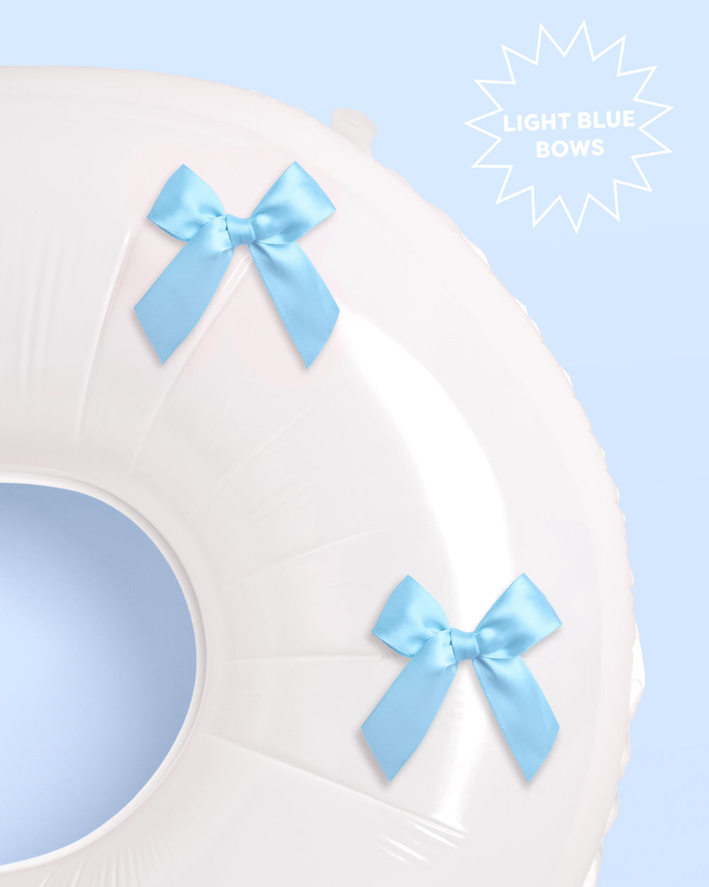 White chair cover with light blue satin bows on a light blue background