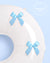 White chair cover with light blue satin bows on a light blue background