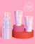 Set of iridescent plastic cups on a pink and red stand with a pink background