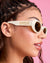 Woman wearing sunglasses with 'Bride' text on a pink background