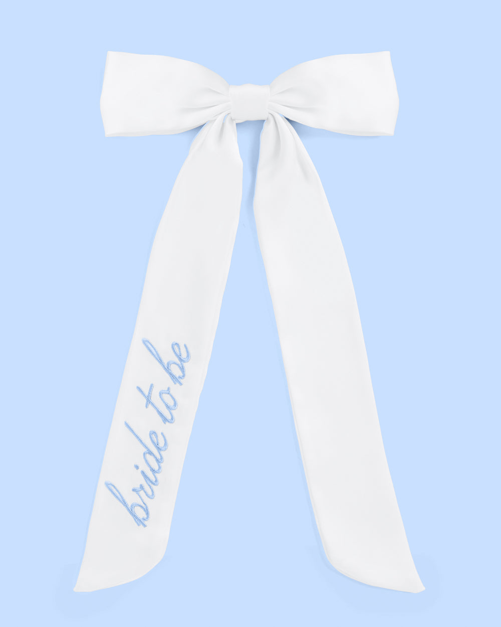 White sash with &#39;bride to be&#39; text on a light blue background