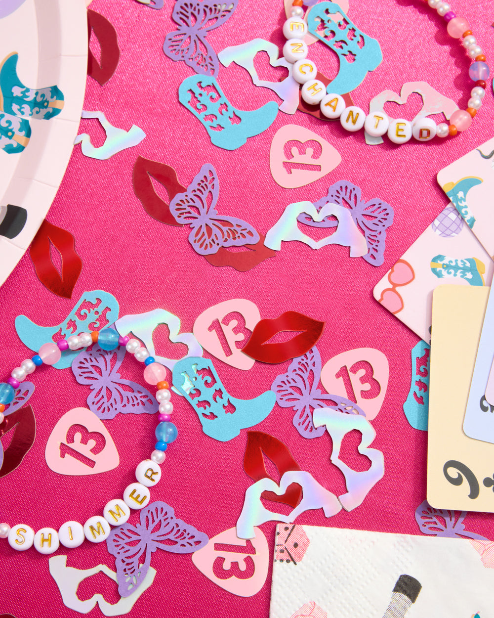 Decorative paper cutouts with numbers and letters on a pink background