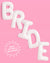 White balloon letters spelling 'BRIDE' on a pink background