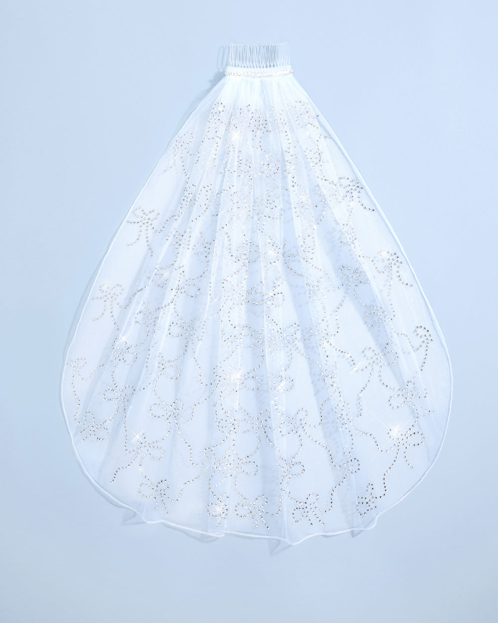 White wedding veil with lace details on a light blue background